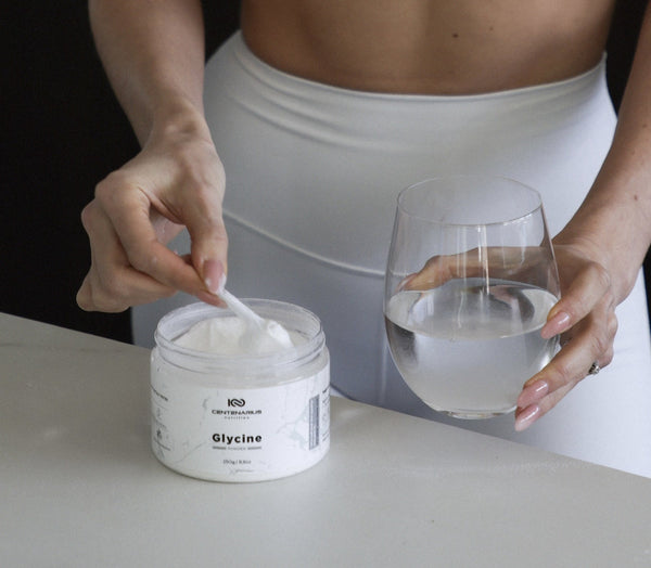Woman preparing glycine powder supplement for sleep, gut health and longevity support